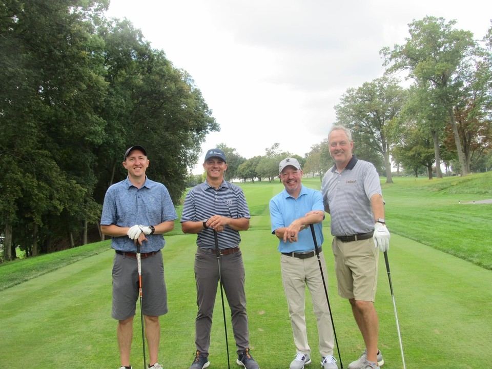 Tom with three peers on a tee box at a PAGCS golf event in Lancaster