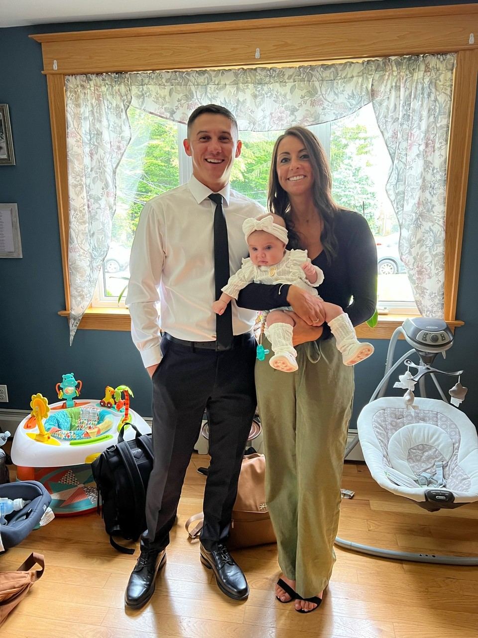 Tom and Briana holding their daughter Mackenzie at her baptism